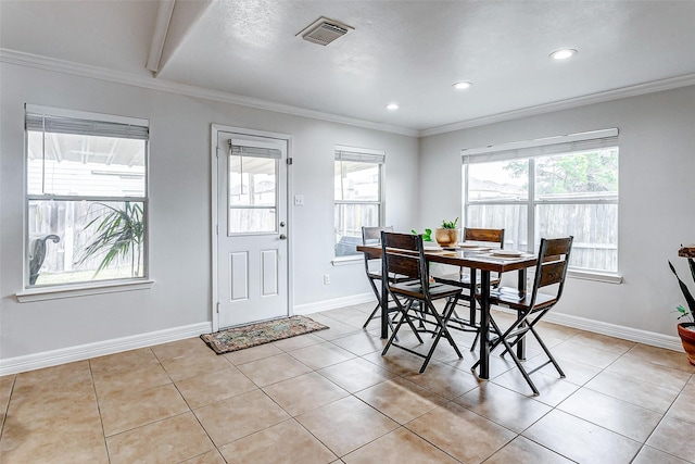 dining area with ornamental molding and light tile patterned floors