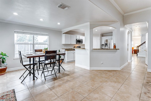 tiled dining space with ornamental molding