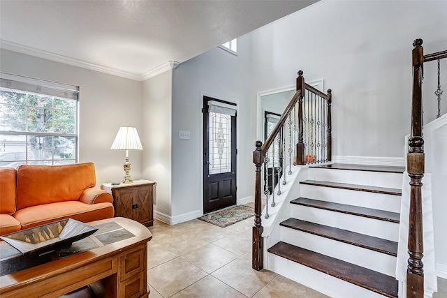 tiled entrance foyer featuring ornamental molding