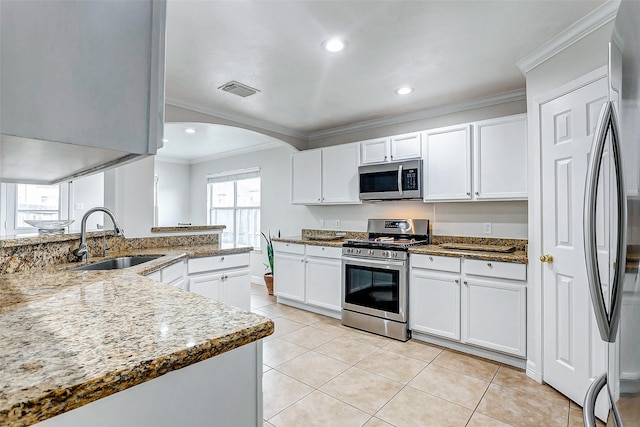 kitchen featuring stainless steel appliances, sink, and white cabinets