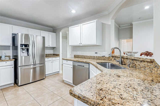 kitchen featuring sink, stainless steel appliances, ornamental molding, light stone countertops, and white cabinets