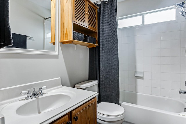 full bathroom with vanity, shower / tub combo, and toilet