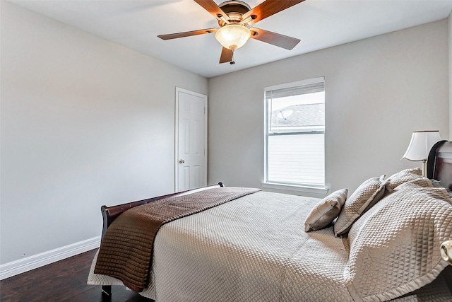 bedroom with dark hardwood / wood-style floors and ceiling fan