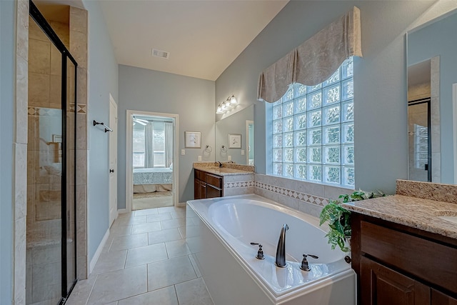 bathroom with tile patterned flooring, vanity, and separate shower and tub