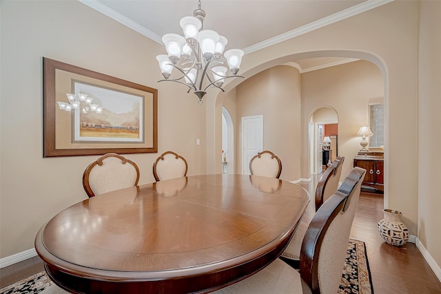 dining area featuring a notable chandelier, wood-type flooring, and ornamental molding