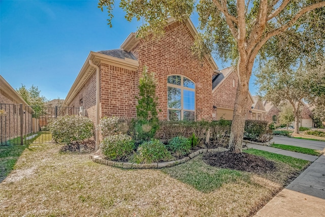 view of side of property with a lawn