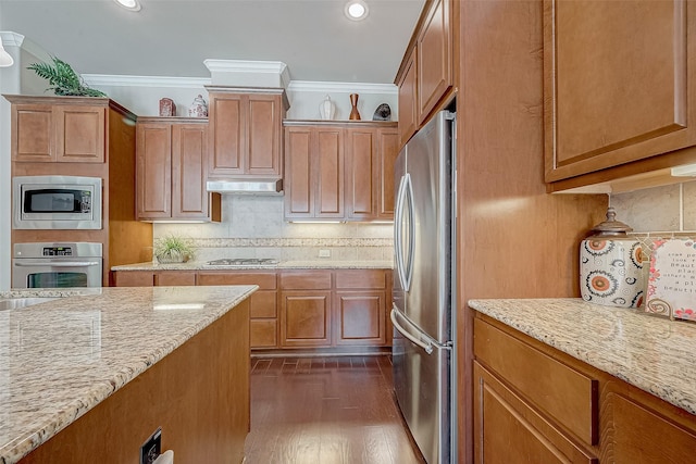 kitchen featuring light stone counters, crown molding, tasteful backsplash, and stainless steel appliances