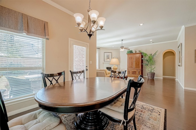 dining area featuring crown molding, ceiling fan with notable chandelier, and hardwood / wood-style flooring