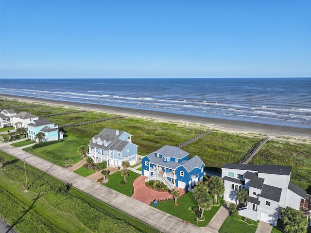 drone / aerial view featuring a water view and a beach view