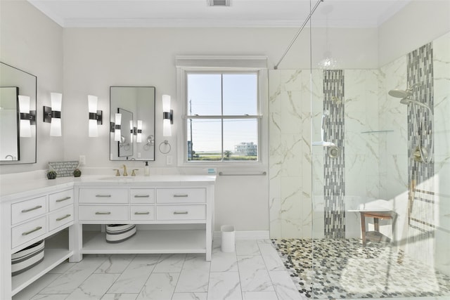 bathroom featuring a tile shower, vanity, and crown molding