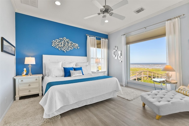 bedroom featuring crown molding, ceiling fan, and light wood-type flooring