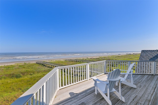 deck with a water view and a beach view