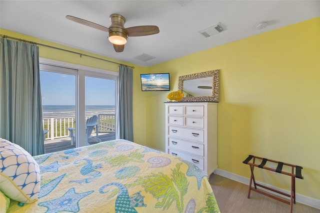 bedroom featuring access to exterior, light hardwood / wood-style flooring, and ceiling fan