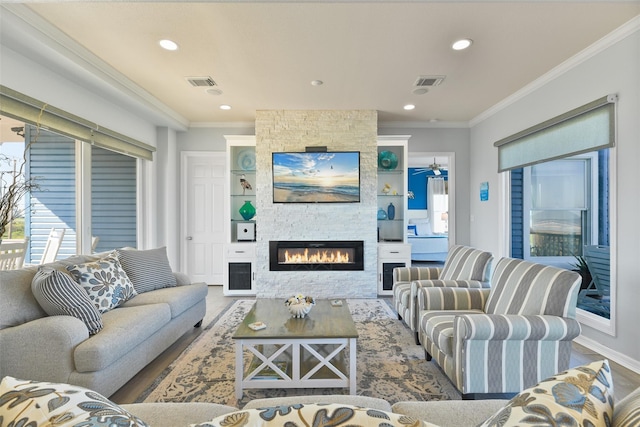 living room featuring ornamental molding and a fireplace