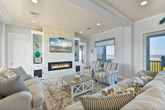 living room with a fireplace and ornamental molding