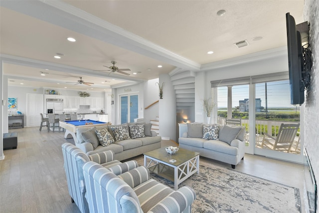 living room featuring crown molding, light hardwood / wood-style flooring, and pool table