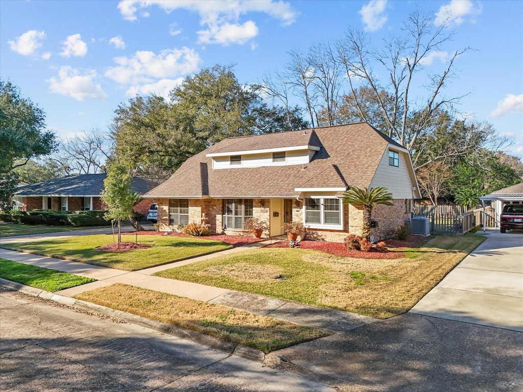 view of front of property featuring central AC and a front yard