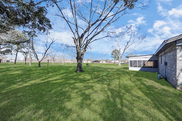 view of yard with a sunroom