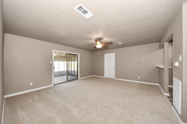 carpeted spare room featuring ceiling fan