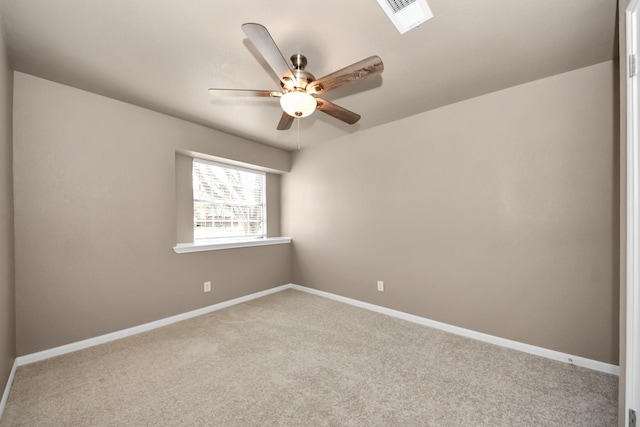 empty room with carpet floors, ceiling fan, and a skylight