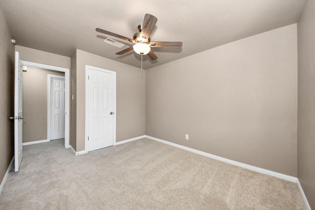 unfurnished bedroom featuring light carpet, ceiling fan, and a closet