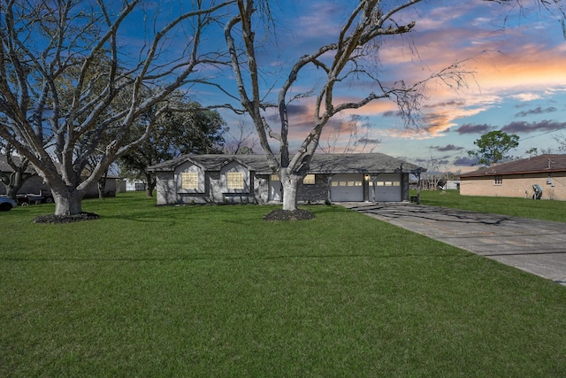 single story home featuring a yard and a garage