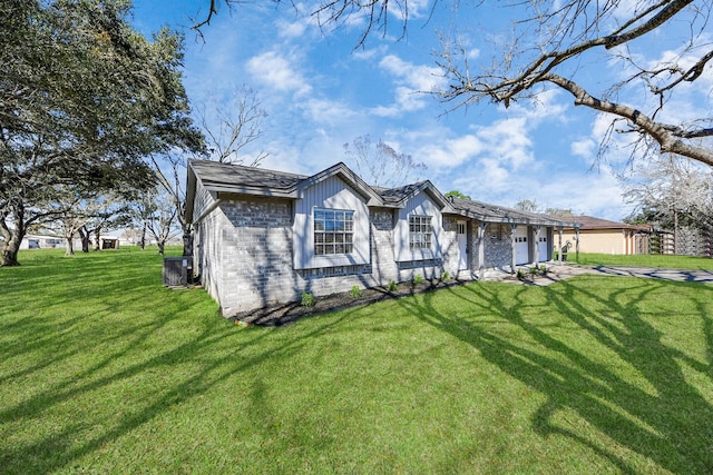 single story home with a garage and a front lawn