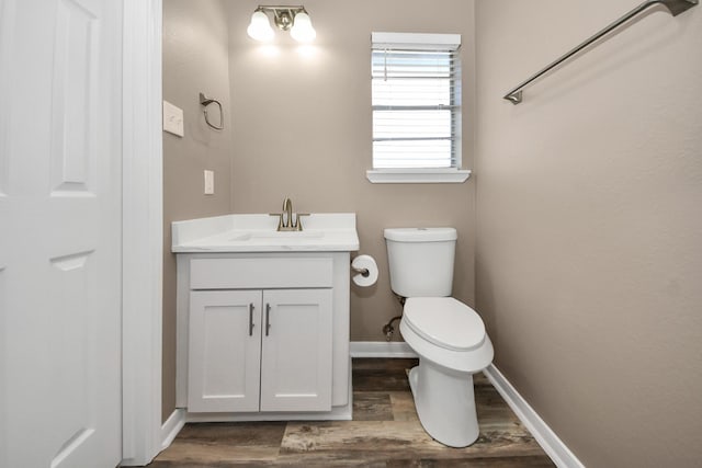 bathroom featuring hardwood / wood-style flooring, vanity, and toilet