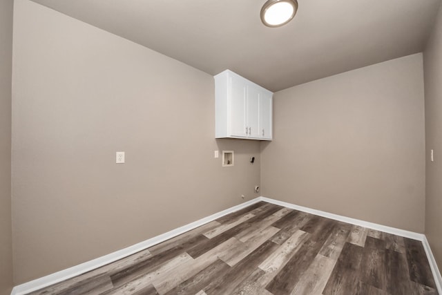 clothes washing area with cabinets, hookup for a washing machine, hookup for an electric dryer, and dark hardwood / wood-style flooring