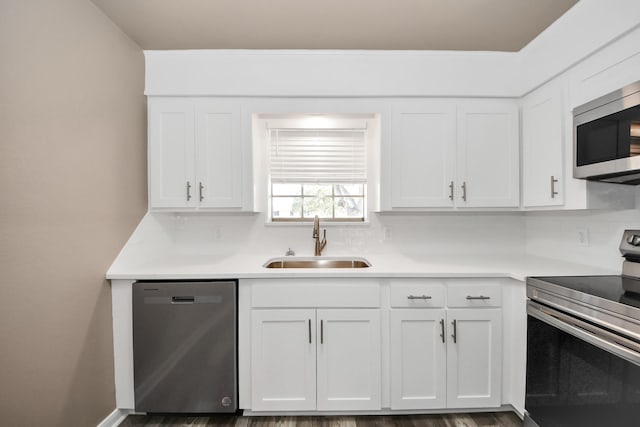 kitchen featuring white cabinetry, sink, decorative backsplash, and stainless steel appliances