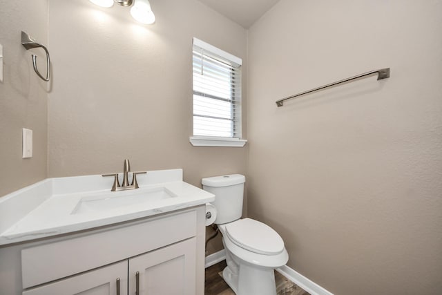 bathroom featuring hardwood / wood-style flooring, vanity, and toilet