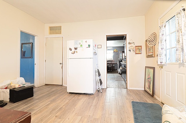 entryway with light hardwood / wood-style floors