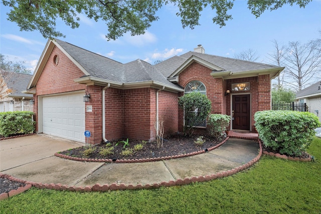 view of front of property featuring a garage and a front yard