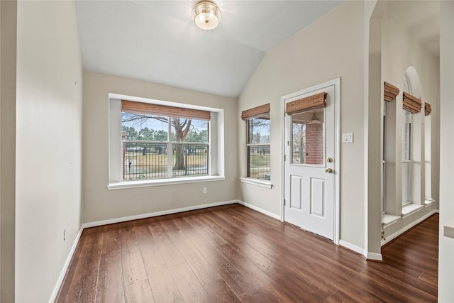 entryway with dark hardwood / wood-style flooring and vaulted ceiling