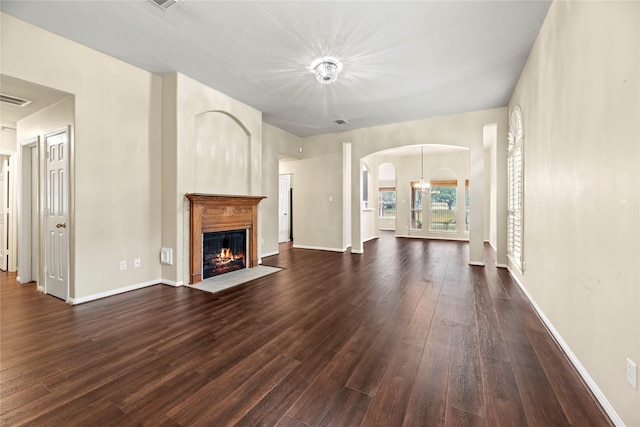 unfurnished living room featuring dark hardwood / wood-style flooring