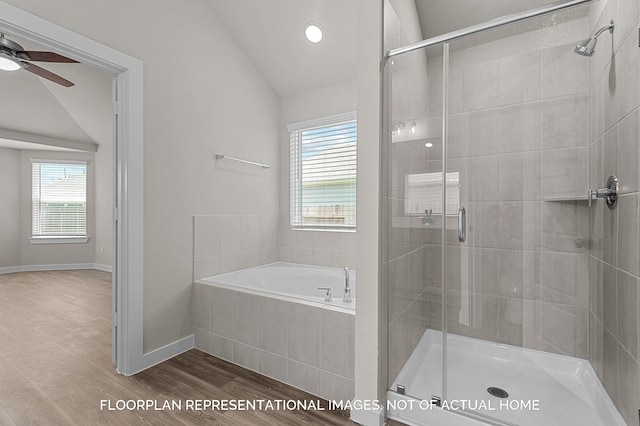 bathroom featuring a stall shower, baseboards, wood finished floors, vaulted ceiling, and a bath