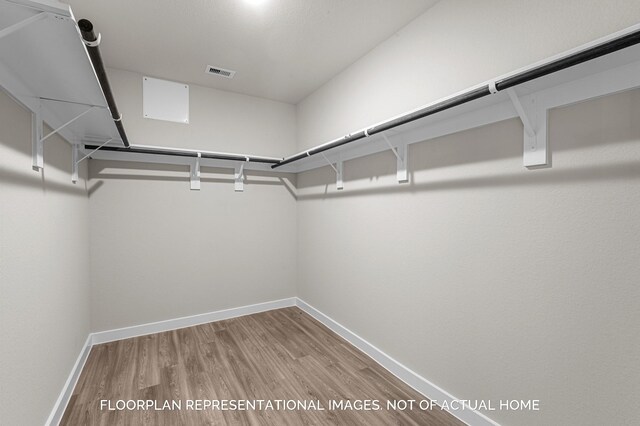 spacious closet featuring hardwood / wood-style floors