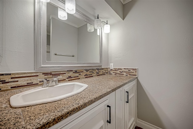 bathroom with tasteful backsplash and vanity