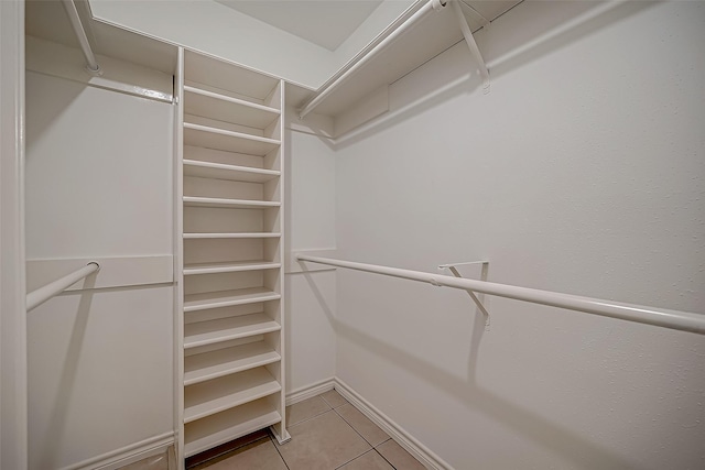 spacious closet featuring light tile patterned floors