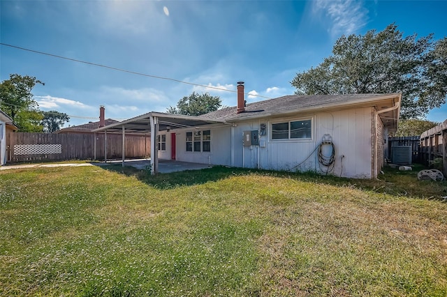 rear view of property featuring a patio and a yard