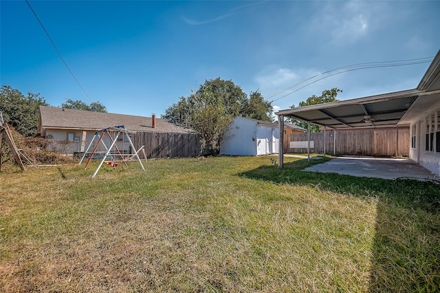 view of yard featuring a playground and a patio area