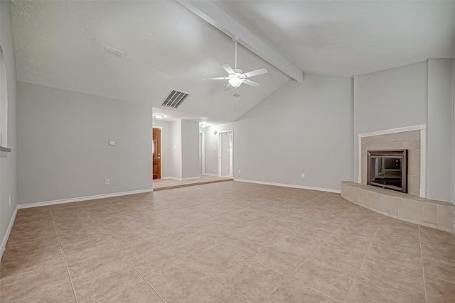 unfurnished living room with vaulted ceiling with beams, a fireplace, ceiling fan, and light tile patterned flooring