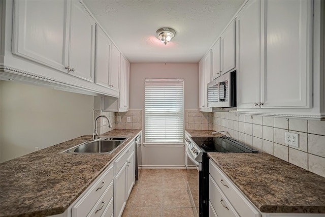 kitchen featuring white cabinetry, appliances with stainless steel finishes, sink, and light tile patterned floors