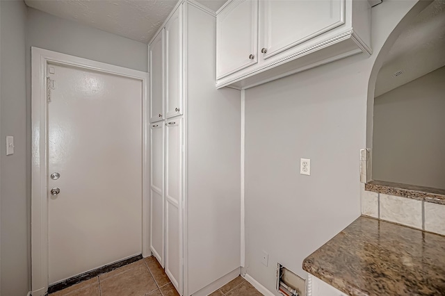 kitchen with white cabinetry and light tile patterned floors