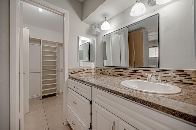 bathroom featuring tasteful backsplash, tile patterned floors, and vanity