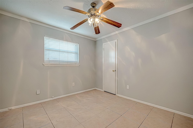 spare room featuring light tile patterned floors, a textured ceiling, ornamental molding, and ceiling fan