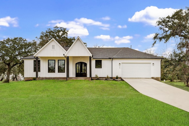 modern farmhouse with a garage, a front lawn, and french doors