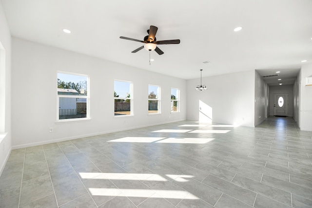 unfurnished living room featuring ceiling fan with notable chandelier and light tile patterned floors