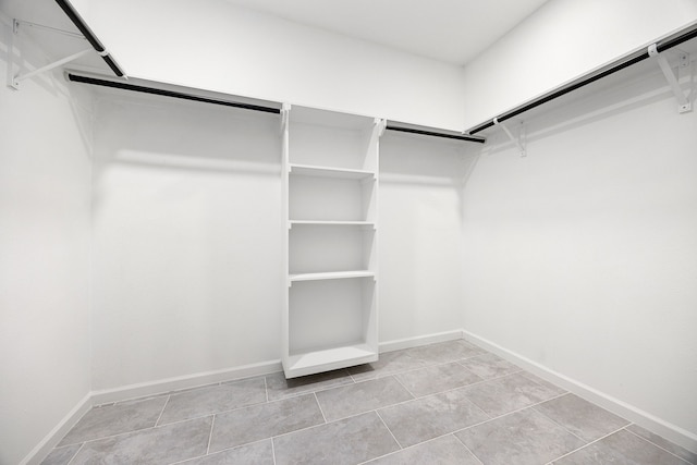 spacious closet with light tile patterned floors