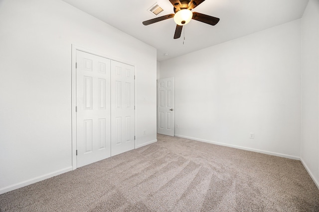 unfurnished bedroom with carpet, ceiling fan, and a closet